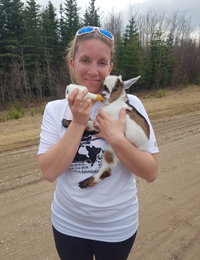 Kristie-feeding-a-baby-goat-on-the-side-of-the-road-May-7,-2018